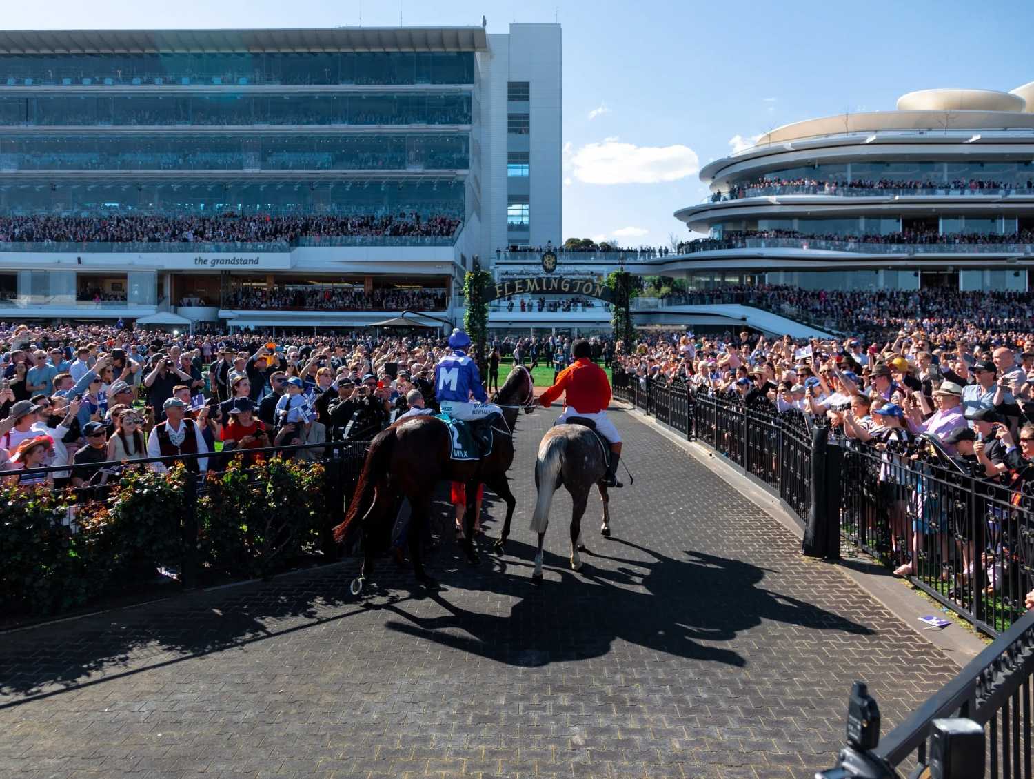 Crowed of people watching Men riding