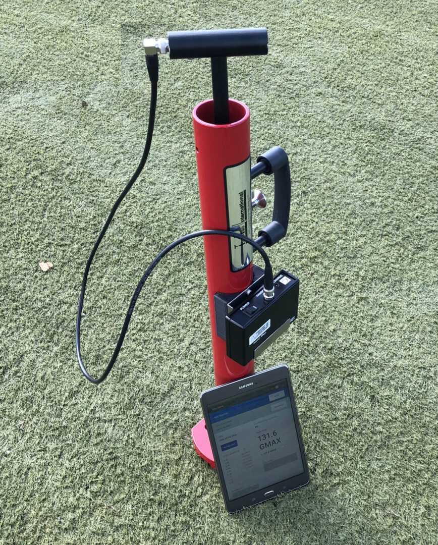 A pumping machine in red color and a phone